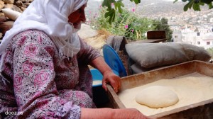 أم خالد 73 عاماً تخبز يومياً في طابونها منذ عقود طويلة، وتقول بأنها كانت تخبز على "الصاج" قبل الطابون، لسهولة نقله من مكان لآخر.